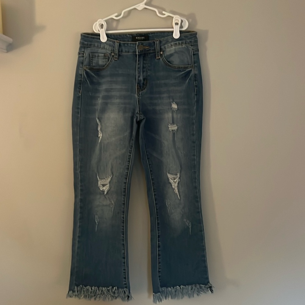 mid rise distressed jeans with very frayed ankles, slightly cropped, stretchy